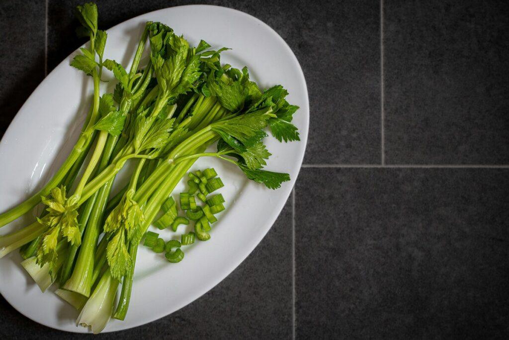 chopped fresh celery on plate safe for dogs